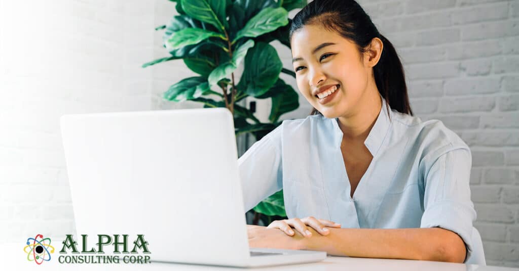 Woman smiling on a laptop